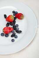 berries on white plate