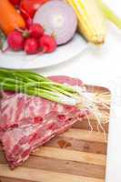 chopping fresh pork ribs and vegetables