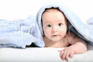 Baby after bath under a blanket