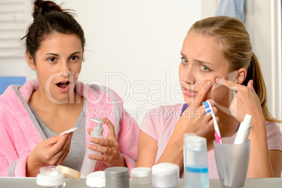 Young teenagers with acne problem in bathroom