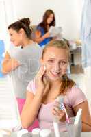 Teenage girl cleaning face with cotton pad