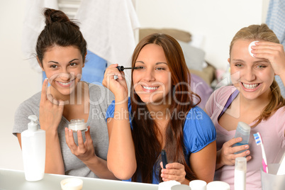 Three teenager girls getting ready in bathroom