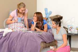 Three teenage girls talking at pajama party