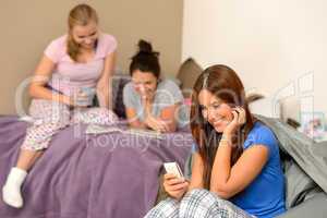 Smiling teenager girl sending text message