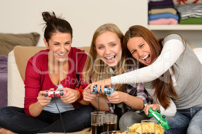 Laughing young girls playing with video games