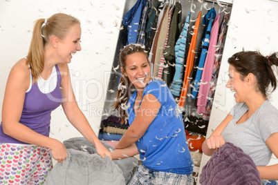 Young laughing girls during pillow fight