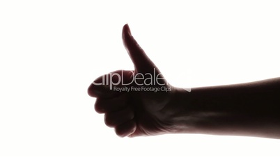A silhouette of a woman's hand giving thumb up.
