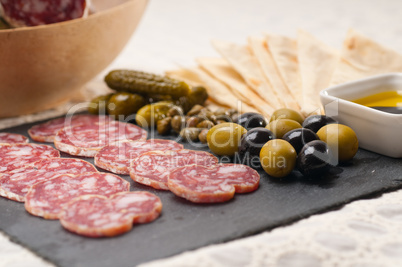 cold cut platter with pita bread and pickles