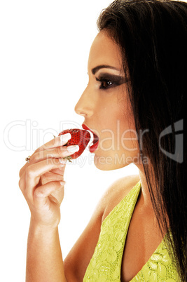 Teen girl eating strawberry.