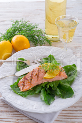 grilled salmon fillets on spinach