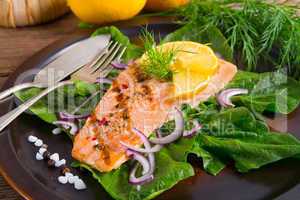 grilled salmon fillets on spinach