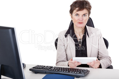 Businesswoman in office with tablet PC