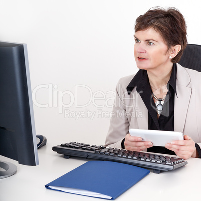 Businesswoman in office with tablet PC