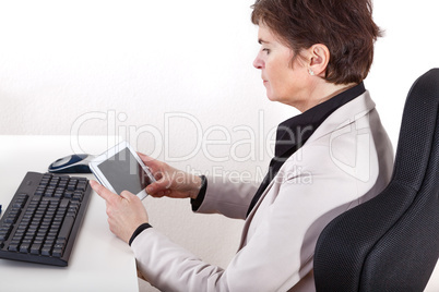 Businesswoman in office with tablet PC