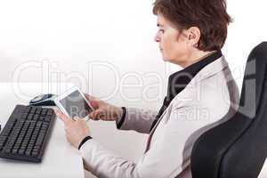 Businesswoman in office with tablet PC