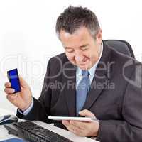 Businessman in office with tablet PC