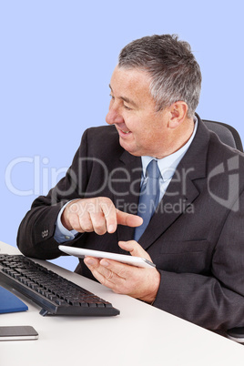 Businessman in office with tablet PC