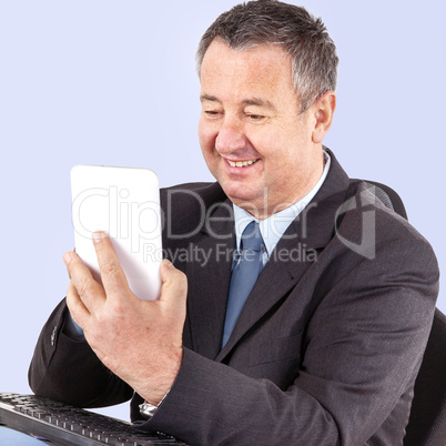 Businessman in office with tablet PC