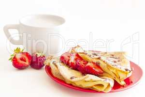 cup of milk and sweet pancakes with strawberry