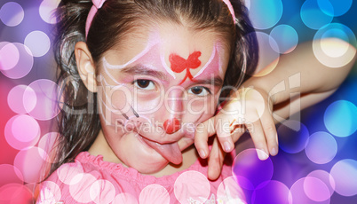 A YOUNG GIRL WITH HER FACE PAINTED
