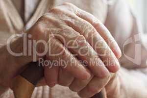 Hand of a senior man with a  cane