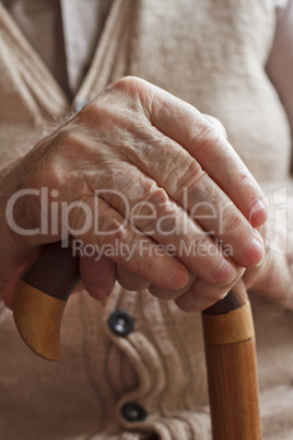 Hand of a senior man with a  cane
