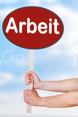 Hands holding a sign with the word arbeit