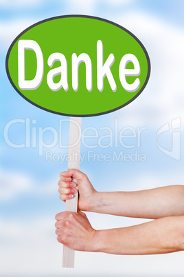 Hands holding a sign with the word danke