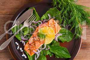 grilled salmon fillets on spinach