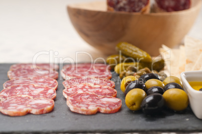 cold cut platter with pita bread and pickles