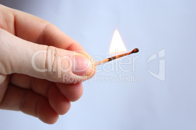 Hand with struck match