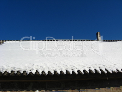 Layer of snow on a roof of the house