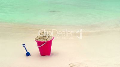 Childs Bucket and Shovel Sitting on Tropical Beach