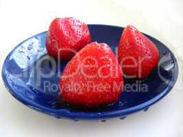 The berries of strawberries on blue saucer