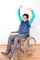Woman in wheelchair with stretching exercises