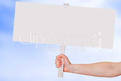 Hand holding blank white sign