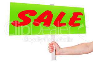 Hand holding sign with inscription SALE