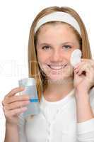 Cheerful smiling girl removing cleaning make-up face