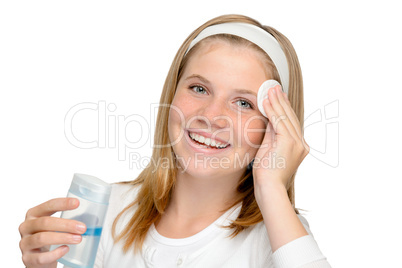 Young cheerful girl removing make-up cleansing pad