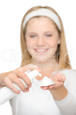 Cheerful teenager girl using cleaning foam cream