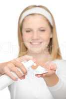 Cheerful teenager girl using cleaning foam cream