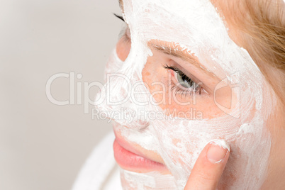 Cheerful teenager girl using face mask cleaning
