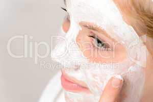 Cheerful teenager girl using face mask cleaning