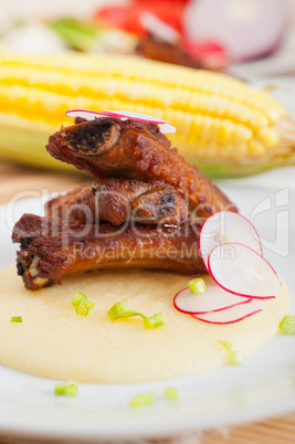 pork ribbs on polenta corn cream bed