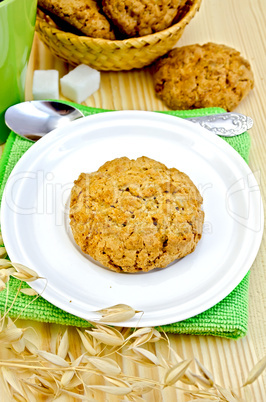 Biscuits with stalks of oats on a wooden board