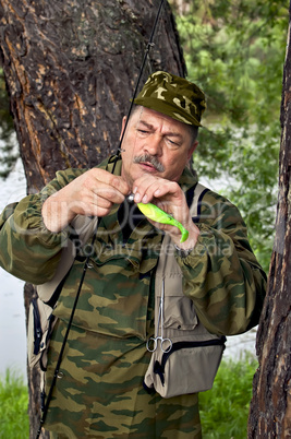 Fisherman with spinning and lure