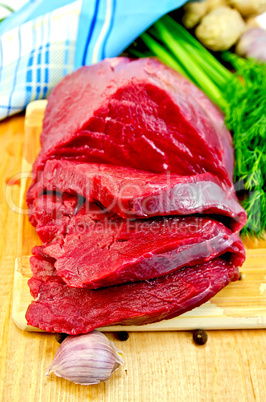 Meat beef on a wooden board with garlic