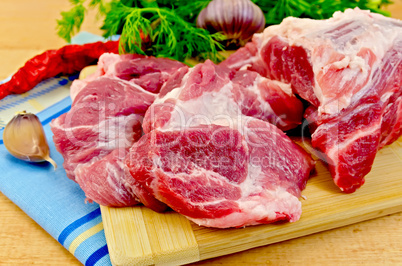 Meat on a wooden board with vegetables