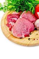 Meat on a round plate with vegetables and herbs