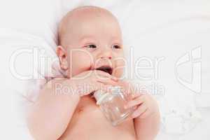 smiling baby drinks water